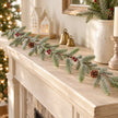 Slim faux fir, red berry and pinecone garland styled along a Christmas mantel
