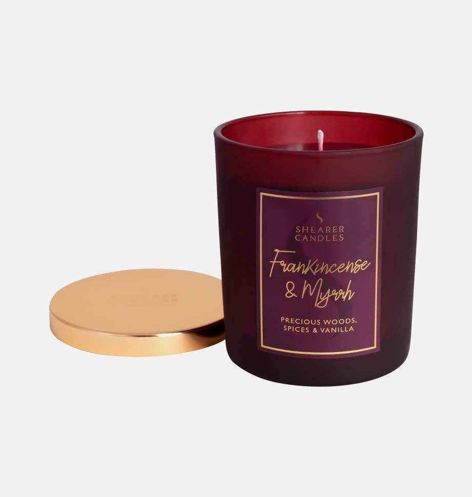 Frankincense and Myrrh Christmas jar candle by Shearer Candles with festive holiday design and warm glowing flame.