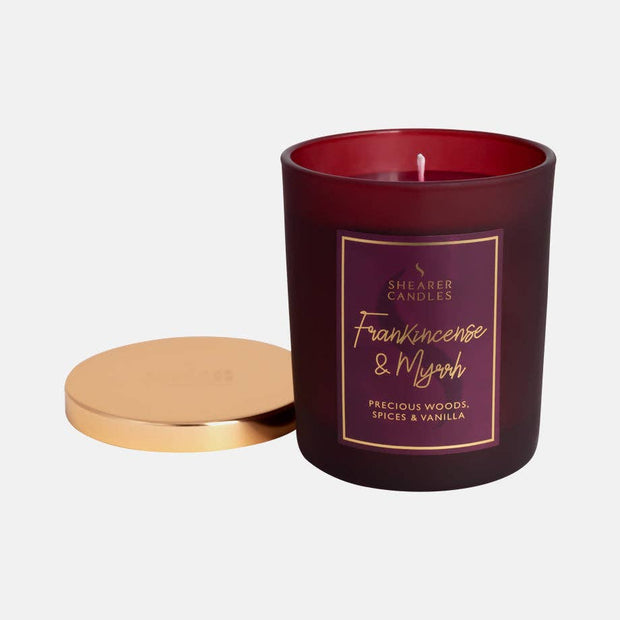Frankincense and Myrrh Christmas jar candle by Shearer Candles with festive holiday design and warm glowing flame.