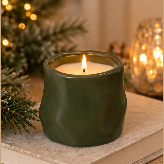 Olive green Satchville sculpted candle in a forest-green design, ideal for home decor and creating a cozy atmosphere.