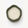 Overhead studio view of forest green sculpted candle showing white wax and central wick