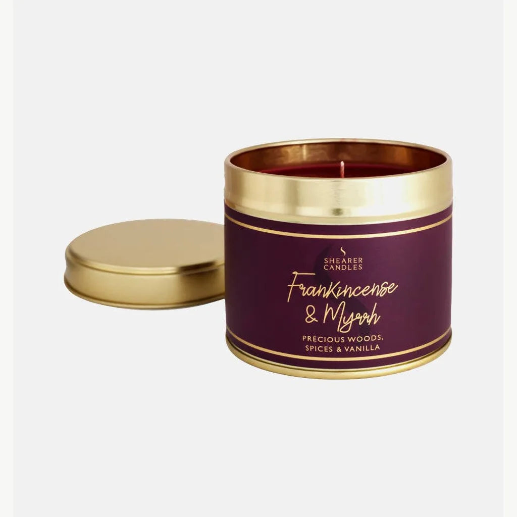 Large Shearer Frankincense and Myrrh burgundy candle tin with gold lid and red wax on white background