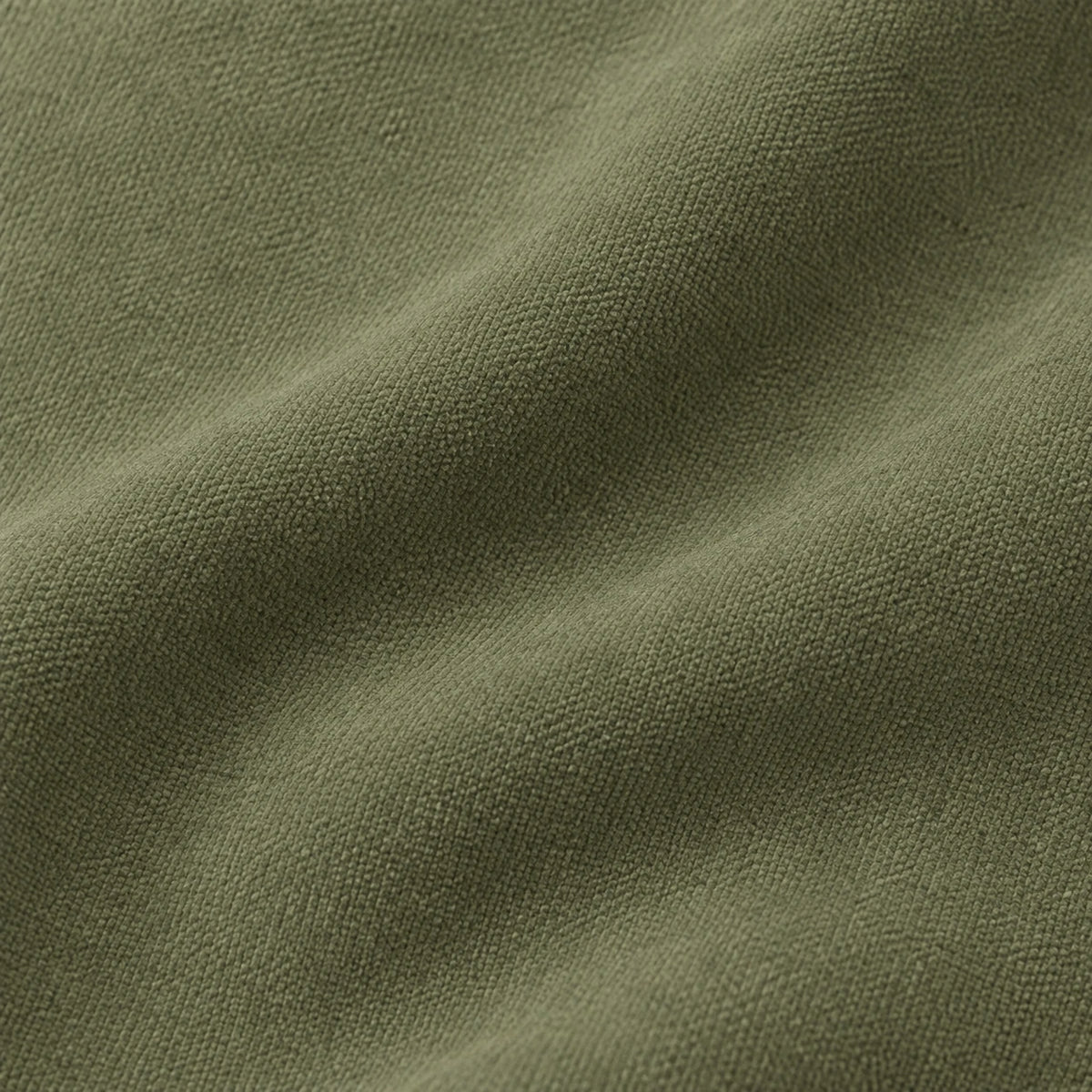 Frayed Edge Olive Green Cushion Cover, close-up of the plain olive fabric and fine woven texture.