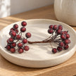 Frosted berry mini stem on a cream ceramic dish