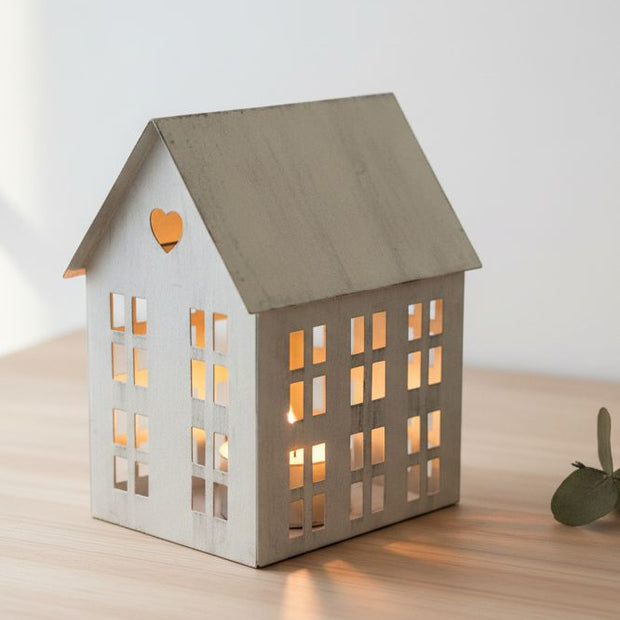 Rustic Metal Tealight House, grey metal house lantern glowing on a wooden surface