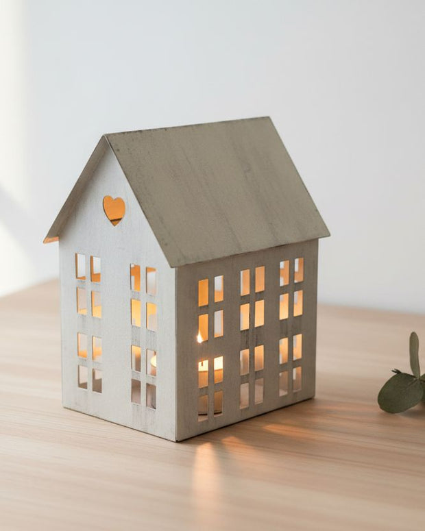 Rustic Metal Tealight House, grey metal house lantern glowing on a wooden surface