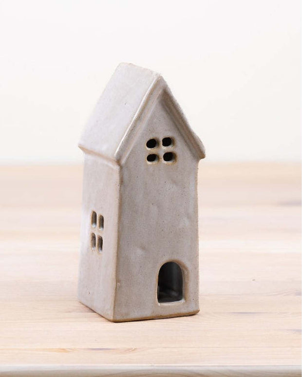 White ceramic LED light-up house home décor by Gainsborough Giftware, showcasing a charming illuminated ceramic house on a flat surface.