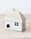 White LED light-up thatched roof cottage decor by Gainsborough Giftware, showcasing a charming miniature home with illuminated roof.
