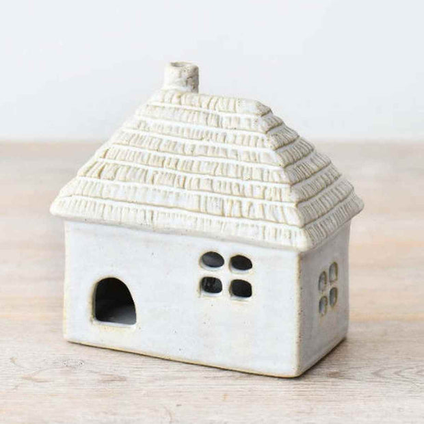 White LED light-up thatched roof cottage decor by Gainsborough Giftware, showcasing a charming miniature home with illuminated roof.