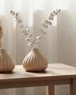 Peach ceramic ribbed bud vase by Gainsborough Giftware, featuring a textured surface and elegant shape for floral arrangements.