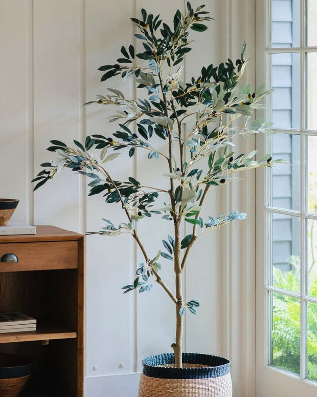 Large artificial faux olive tree by Gallery Direct, showcasing lush green leaves and realistic trunk for indoor or outdoor decor.