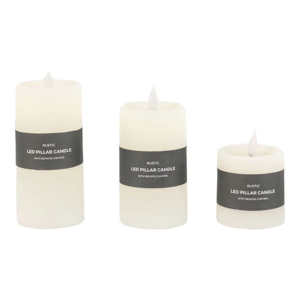 Set of three rustic cream LED battery-operated candles from Gallery Direct, showcasing soft glowing light and realistic flicker.