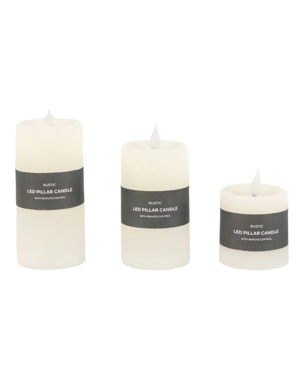 Set of three rustic cream LED battery-operated candles from Gallery Direct, showcasing soft glowing light and realistic flicker.