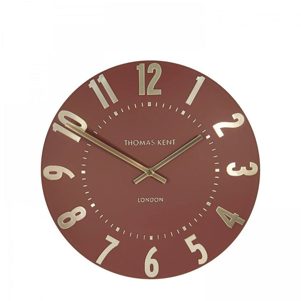 Thomas Kent 12-inch Mulberry wall clock by Gallery Direct, featuring a terracotta-colored round clock with black hands.