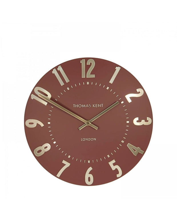 Thomas Kent 12-inch Mulberry wall clock by Gallery Direct, featuring a terracotta-colored round clock with black hands.