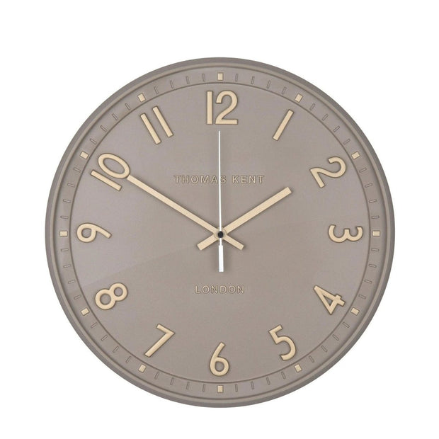 Thomas Kent 14-inch Tresco wall clock in taupe with a round face and minimalist design, mounted on a wall.