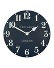 Thomas Kent 20-inch Arabic wall clock in ink blue with bold black numerals, stylishly displayed on a wall.