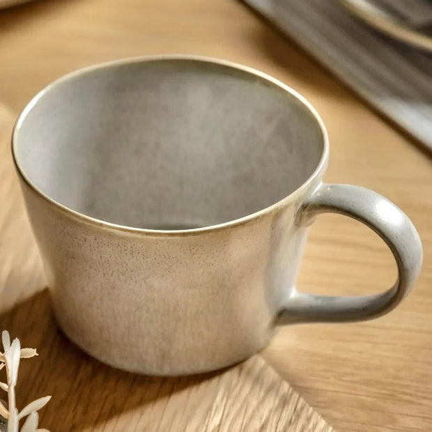 Beige Pebble Dash Reactive Glaze Organic Mug by Gallery Direct, shown on a kitchen countertop with a ceramic finish.