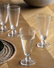 Set of four clear glass swirl flute glasses for elegant kitchen and dining use by Gallery Direct.