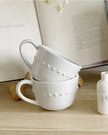 White organic beaded ceramic mug with textured beading, ideal for kitchen and dining, by Gallery Direct.