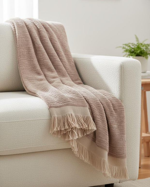 Beige fringed chenille blanket throw from Gallery Direct, soft furnishings with cozy, textured fabric and fringed edges.