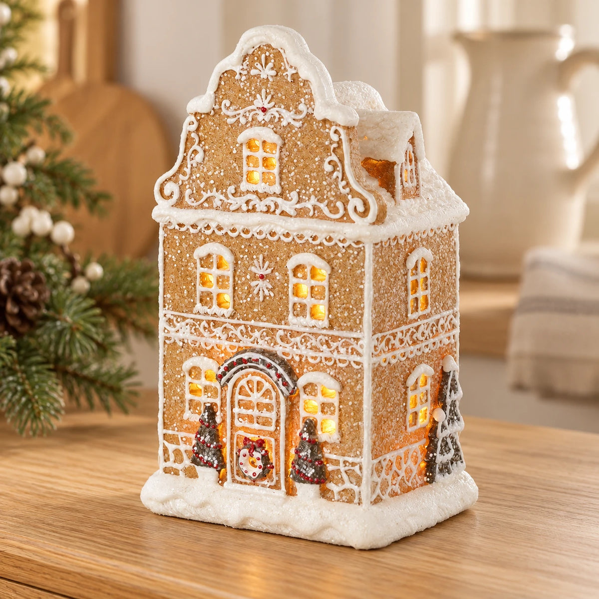 Gingerbread house with trees in a neutral Christmas kitchen