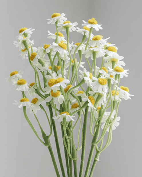 Artificial mini daisy flower bunch by Gisela Graham, realistic yellow and white daisy flowers in a compact arrangement.
