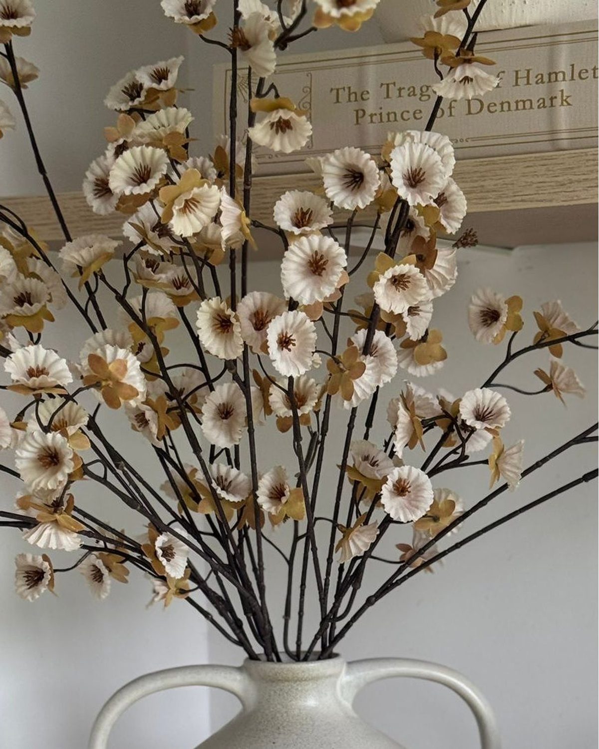 Artificial neutral spring flower stem by Gisela Graham, realistic faux plant with delicate blossoms and green foliage.