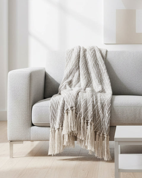 Beige chevron cotton knitted throw blanket by Gisela Graham, showcasing soft, cozy textile with a stylish pattern.