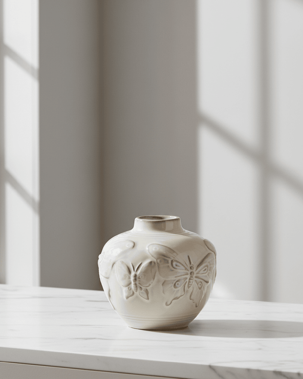 Small taupe porcelain butterfly bud vase by Gisela Graham featuring a delicate butterfly design on a smooth surface.