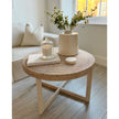 Lows Rattan Round Coffee Table with natural woven rattan surface and wooden legs, perfect for living room decor.