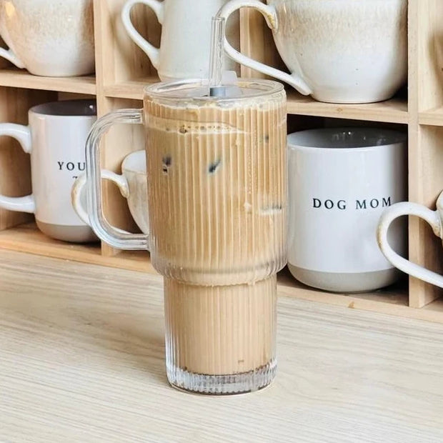 Glass ribbed ‘Stanley’ style iced coffee travel cup by Starlight Express, featuring a clear design with a lid and handle for on-the-go use.