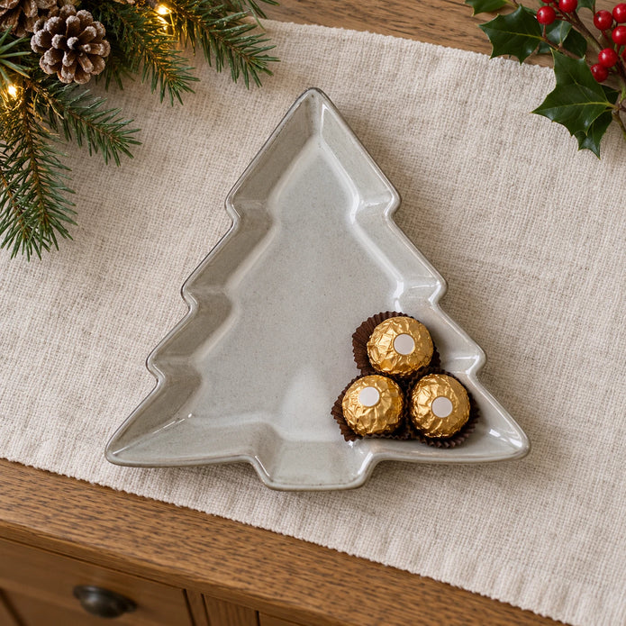 Glazed ceramic tree dish lying flat, with wrapped chocolates