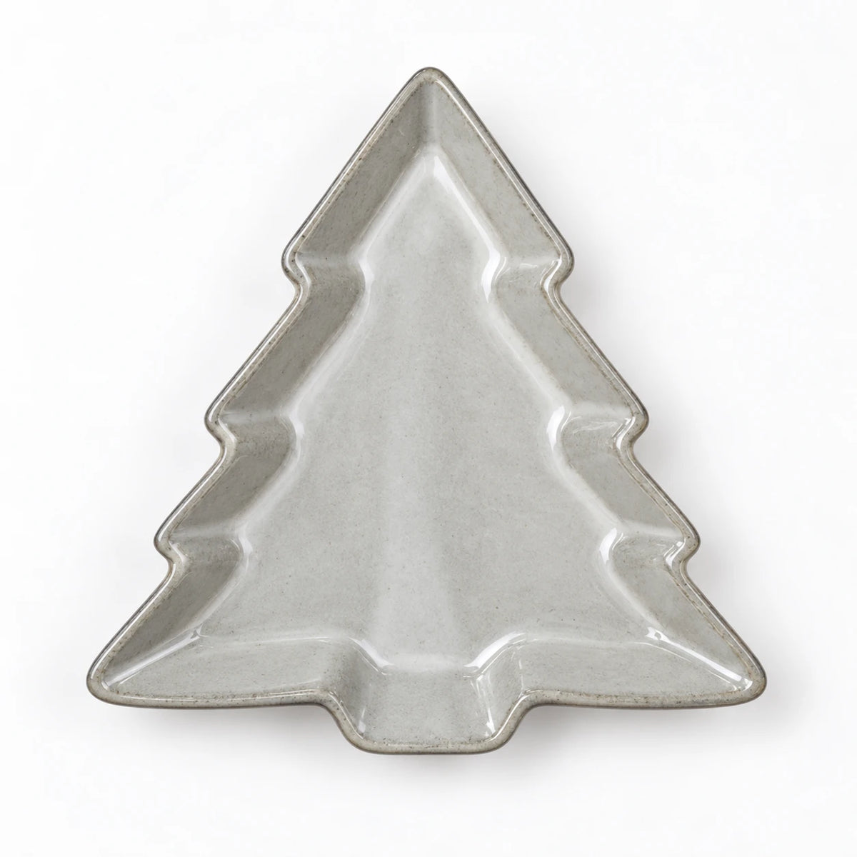 Glazed ceramic tree dish lying flat, empty overhead white studio view