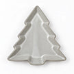 Glazed ceramic tree dish lying flat, empty overhead white studio view