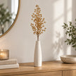 Gold Berries stem in a slim cream vase on an oak console.