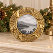 Gold Leaf Botanical round photo frame by Originals International Ltd on a mantelpiece