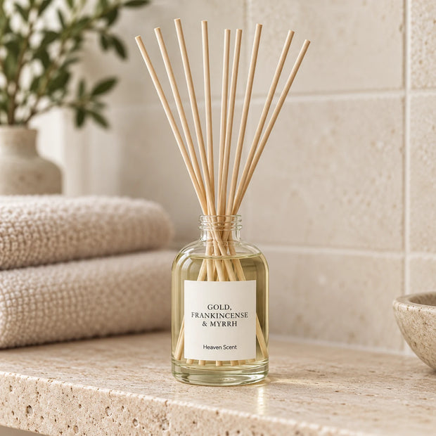 Gold, Frankincense And Myrrh Reed Diffuser styled on a stone bathroom shelf with reeds inserted.