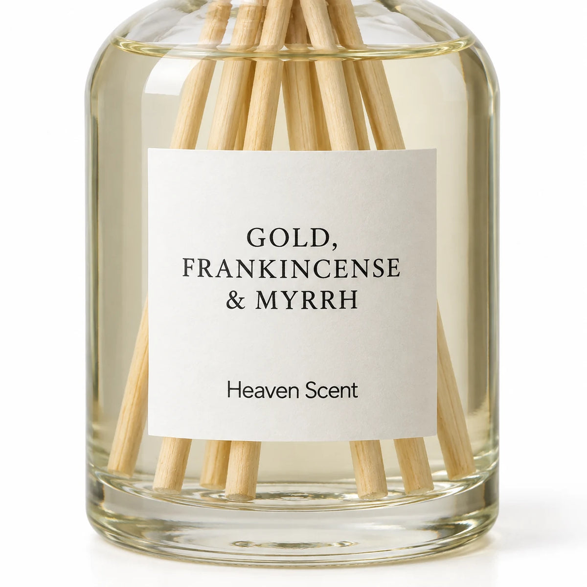 Gold, Frankincense And Myrrh Reed Diffuser close-up of the fragrance label and glass bottle.