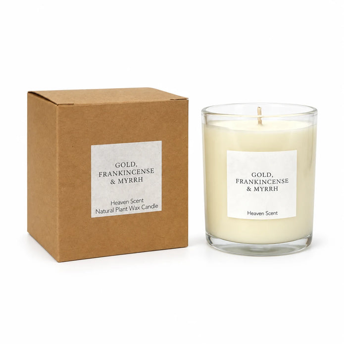 Heaven Scent Gold, Frankincense & Myrrh Medium Candle, unlit with its brown kraft box against white