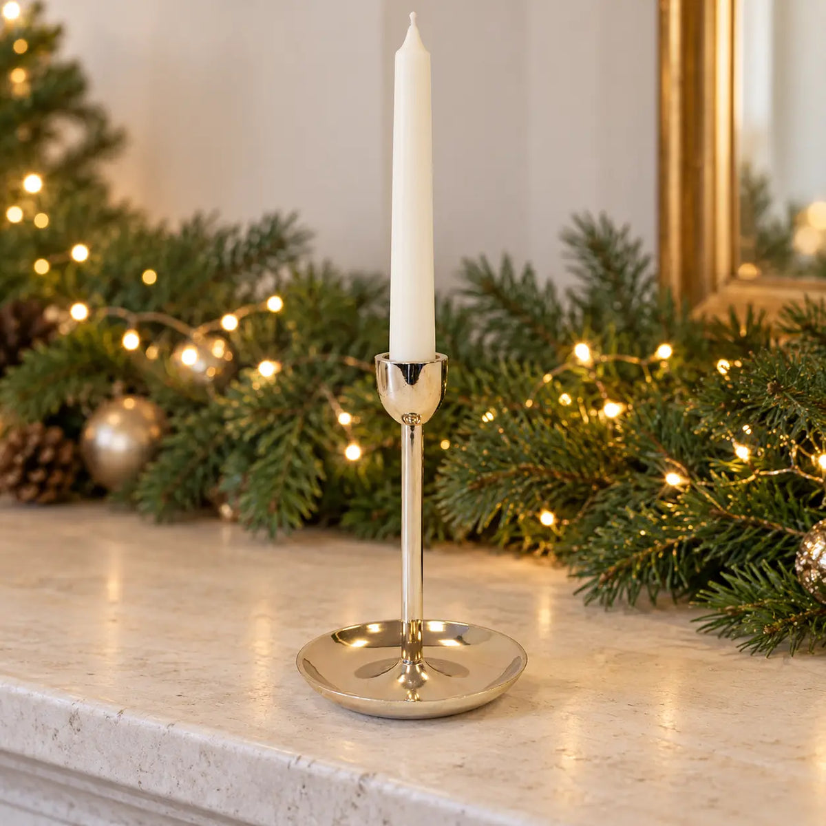 Small gold metal candlestick holder from Satchville, designed for elegant candle display on mantels or tabletops.