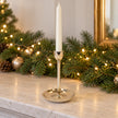 Small gold metal candlestick holder from Satchville, designed for elegant candle display on mantels or tabletops.