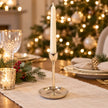 Small gold metal candlestick holder by Satchville, featuring a sleek, modern design for tabletop decoration or candle display.