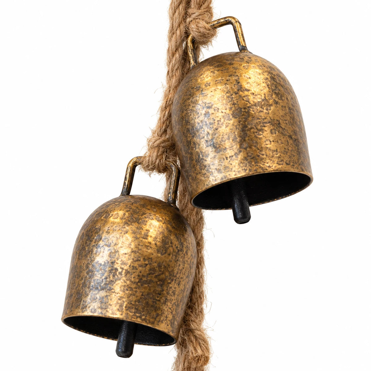 Close-up of antiqued gold metal cowbells, dark clappers and natural jute rope connections