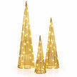 Three gold TreeBelisk cone trees with warm lights on a white studio background.