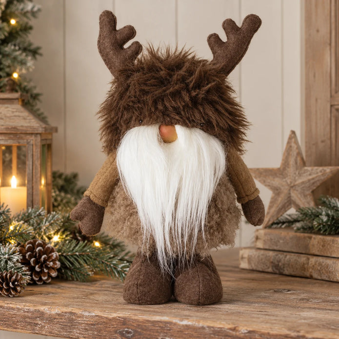 Christmas reindeer gonk with brown felt antlers and long white beard on wooden country-home shelf