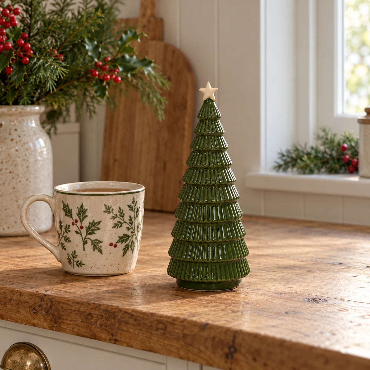 Green Satchville ceramic Christmas tree, 20cm tall, displayed on a kitchen scale