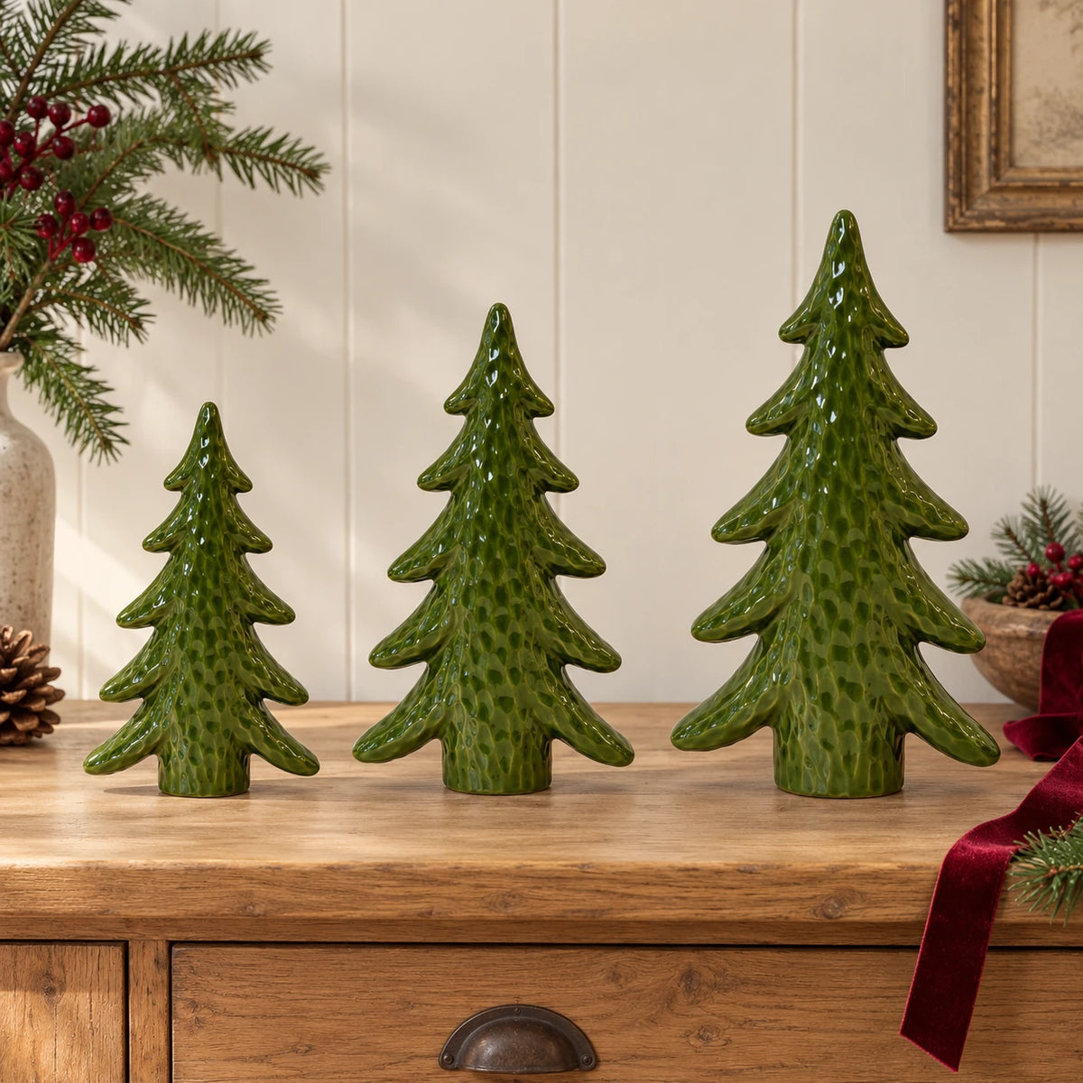 Satchville extra large green ceramic Christmas tree ornament displayed with smaller sizes