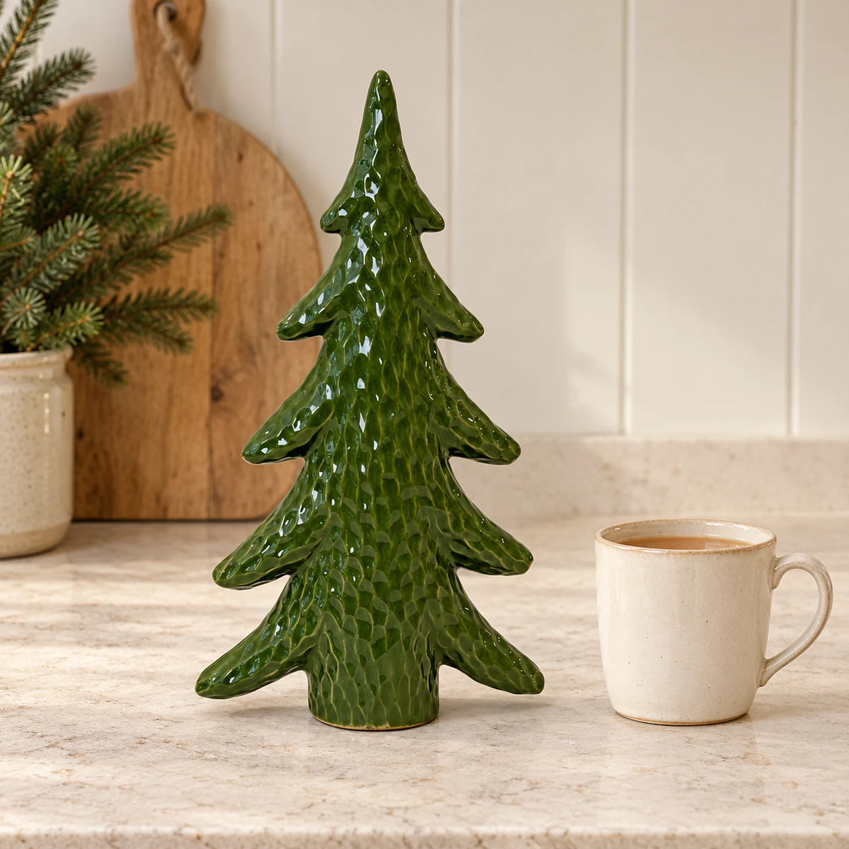 Satchville extra large green ceramic Christmas tree ornament on a kitchen scale