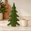 Satchville extra large green ceramic Christmas tree ornament on a kitchen scale